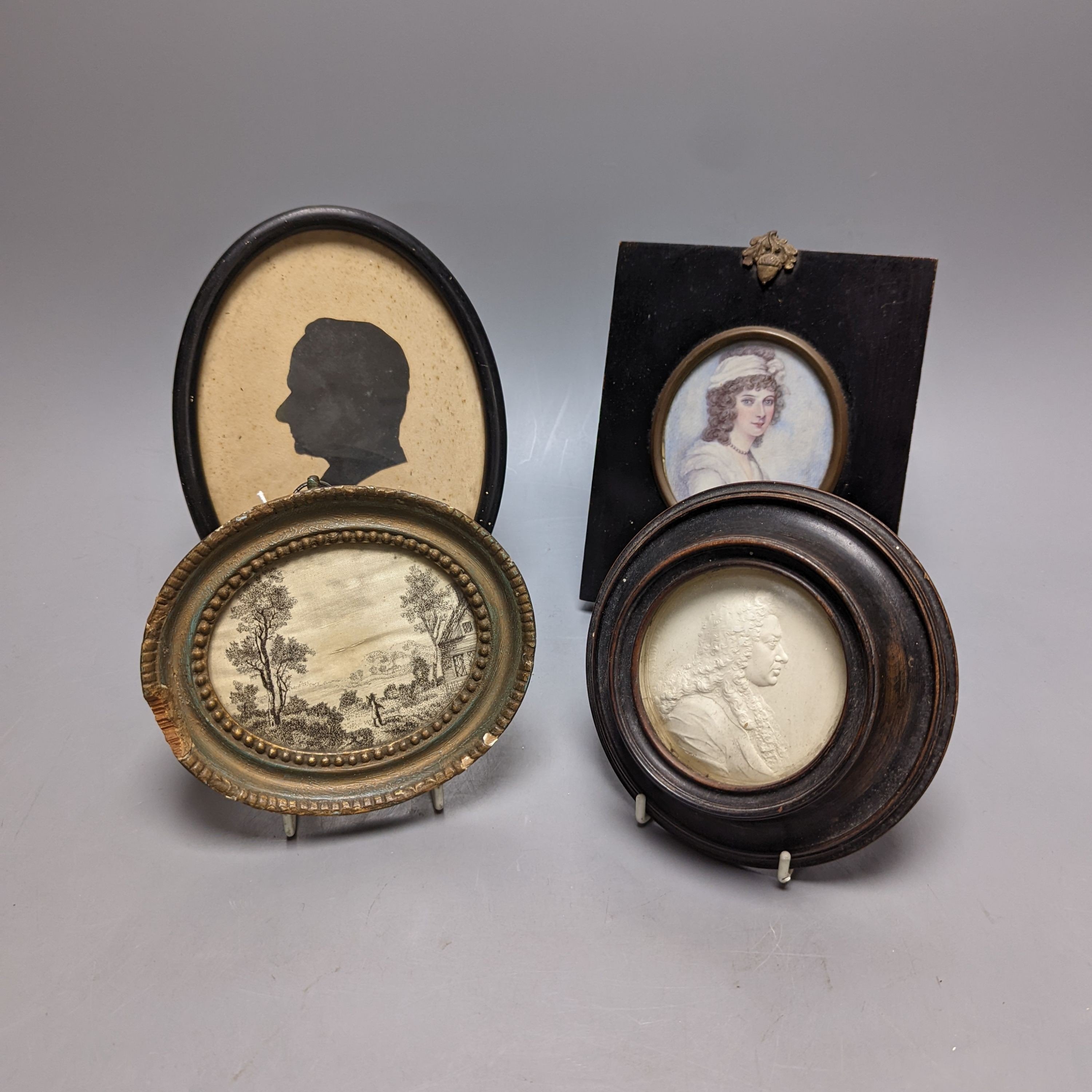 A plaster relief portrait, Samuel Pepys, frame 13cm., a Victorian portrait miniature on ivory, a silhouette portrait and a woven silk picture